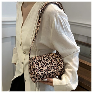 Detailed view of leopard print crossbody bag with wide adjustable shoulder strap
