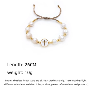 Detailed view of Baroque pearl bracelet with golden beads and a cross charm pendant