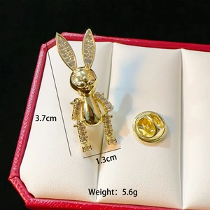 Golden rabbit brooch with rhinestones in red jewelry box, size 3.7cm x 1.3cm