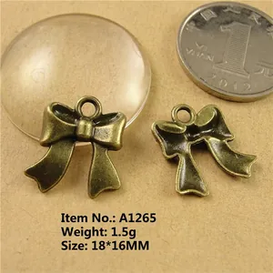 Detail of 18x16mm antique bronze bow charms for DIY jewelry making weighing 1.5g