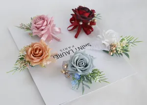 Detailed view of artificial rose corsages in five colors with silk ribbons and golden beads