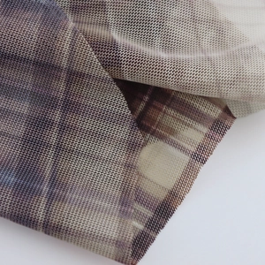 Close-up of vintage purple plaid mesh fabric showing breathable texture and drapery