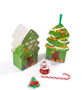 Detailed view of Christmas tree shaped green gift boxes with festive ribbon and patterns