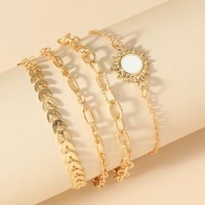 Detail of a 4-piece gold chain bracelet set featuring sun flower charm and varied link styles