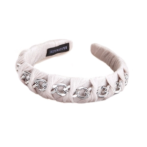 Vintage beige fabric headband intertwined with silver metal chain on white background