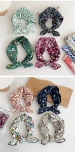 Flat lay of multiple printed cotton-linen hair scarves in floral and paisley patterns