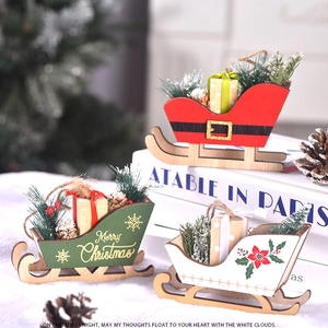 Close-up of wooden Christmas sleigh decorations with pine cones and small gift boxes
