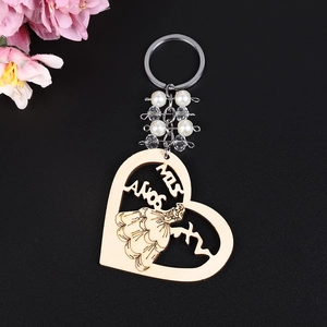 Wooden heart keychain with princess carving, MIS AÑOS text and faux pearl chain charm