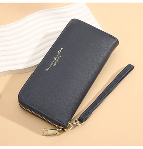 Detail of navy blue cross-grain leather long wallet with gold zipper and wrist strap