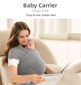 Detail of grey wrap baby carrier showing cross-wrap structure in a cozy home setting