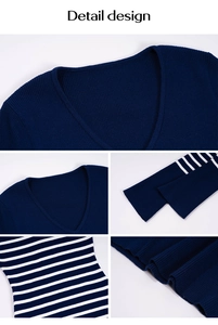 Détails d'un pull en maille bleu foncé avec col en V et rayures blanches aux poignets