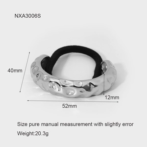 Detail showing irregular hammered silver metal charm dimensions and black elastic hair tie