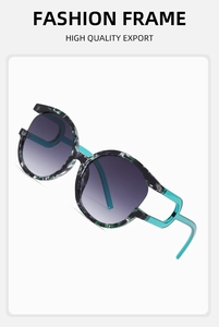 Detail of round sunglasses with green floral frame and blue temples with purple gradient lenses