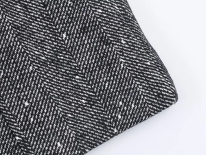 Macro shot of high-quality black and white herringbone tweed fabric texture