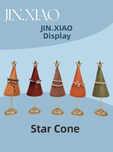 Detailed view of colorful velvet star cone jewelry display stands with gold star finials
