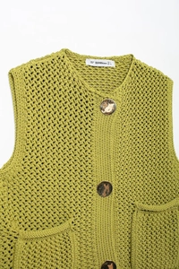 Detailed flat lay of a lime green knit vest with gold buttons and front patch pockets