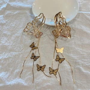 Golden butterfly hair claw clips with dangling tassels and metal charms for women