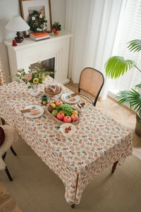 Close-up of beige cotton linen tablecloth featuring festive gingerbread man pattern