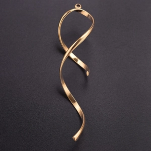 Detail of 304 stainless steel gold ribbon pendant with metallic spiral texture