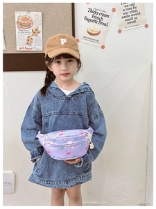 Detailed view of kids purple fanny pack with cute patterns and white bunny charm pendant