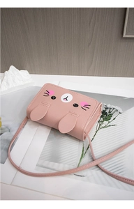 Detailed close-up of a pink rabbit-shaped crossbody bag made of soft PU leather