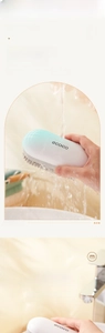 Detail of ergonomic laundry brush with soft dense bristles and streamlined green handle