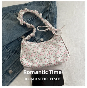 Floral shoulder bag size comparison with a smartphone showing its large capacity