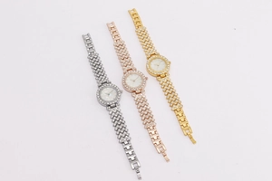 Detailed view of three luxury women's crystal watches in silver, rose gold, and gold finish
