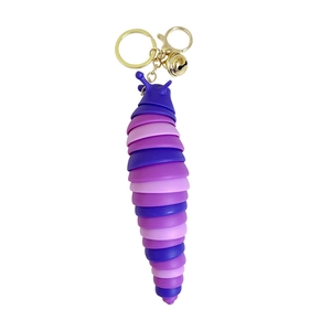 Purple articulated slug keychain with gold bell and ring on a clean white background