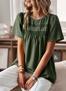 Detailed close-up of army green blouse featuring delicate lace trim and textured fabric