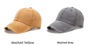 Close-up of washed cotton baseball caps in yellow and grey showing retro texture
