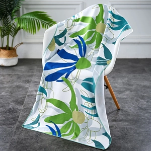 Microfiber beach towel with blue floral print draped over a modern chair for home use