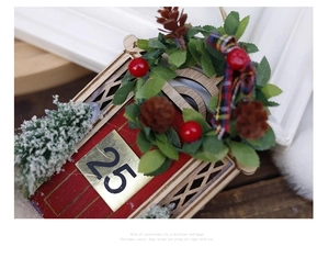Detail of wooden Christmas door hanger with green wreath and festive number 25