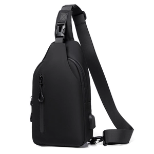 Detail view of black crossbody chest bag featuring integrated USB charging port for men