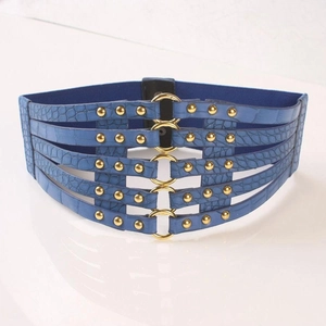 Detail of dark blue wide corset belt with crocodile pattern and gold rings