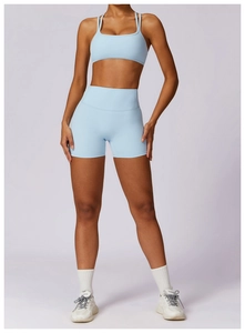 Close-up of light blue quick-dry yoga set showing the slim fit sports bra and high-waist shorts