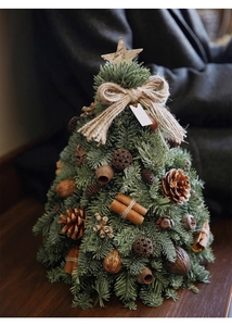 Detail of DIY Christmas tree with pine cones, cinnamon sticks and hemp rope decor