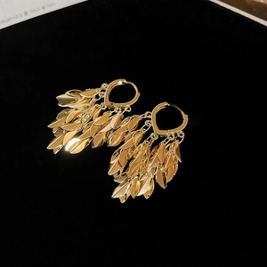 Elegant gold leaf tassel earrings with polished mirror finish and hoop closure
