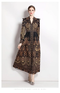 Detail of V-neck long dress featuring orange-gold paisley print and cinched waist