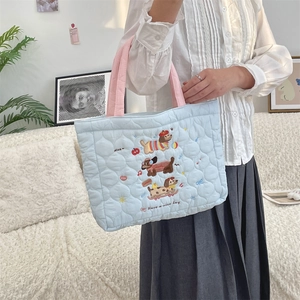 Quilted cotton handbag with cute dog embroidery and pink handles shown on model