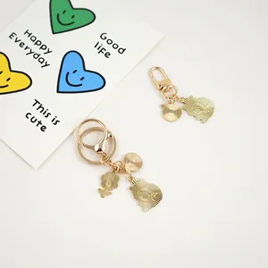 Golden Chiikawa capybara keychain with cute alloy charms on a clean white background