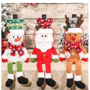 Close-up of Santa, Snowman, and Reindeer plush wine bottle covers with long legs
