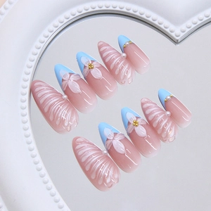 Blue French almond press-on nails with 3D pearls and white floral designs on mirror