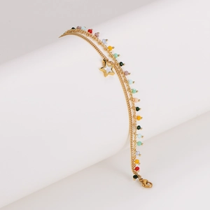 Double-layered colorful beaded bracelet with gold star charm on a white pedestal