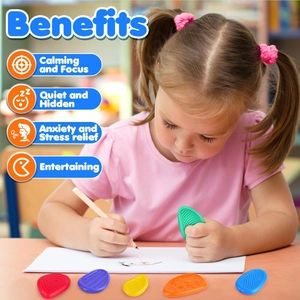 Child using colorful textured silicone sensory stones for stress relief and focus on a desk