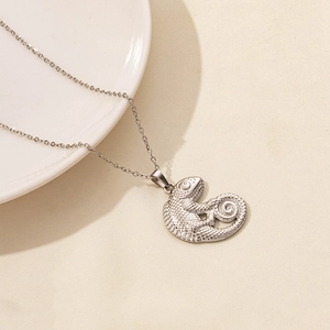 Detailed macro view of a silver chameleon pendant necklace with realistic scale textures