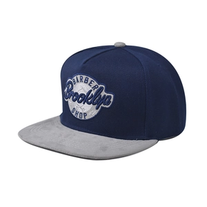 Detailed embroidery of Brooklyn Barber Shop logo on two-tone snapback baseball cap