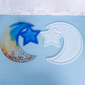 Detail of moon and star tray resin mold with finished blue and gold sparkling tray