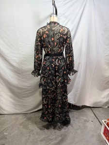 Back view of paisley printed maxi dress with ruffled tiers and a black waist belt