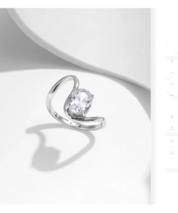 Macro detail of S925 sterling silver stamp and oval zircon inlay on irregular ring